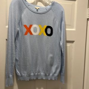 Long sleeve light blue sweater.